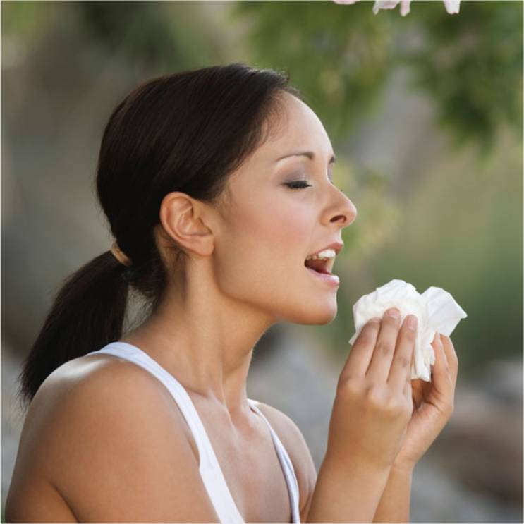 A woman about to sneeze.